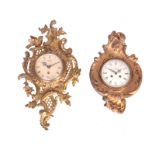 TWO CARTEL STYLE WALL CLOCKS the larger with gilt brass scrollwork case enclosing a 4.5" painted