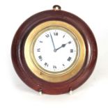 AN EARLY 20TH CENTURY CAR CLOCK having a brass case with bayonet fitted dashboard mount, the white
