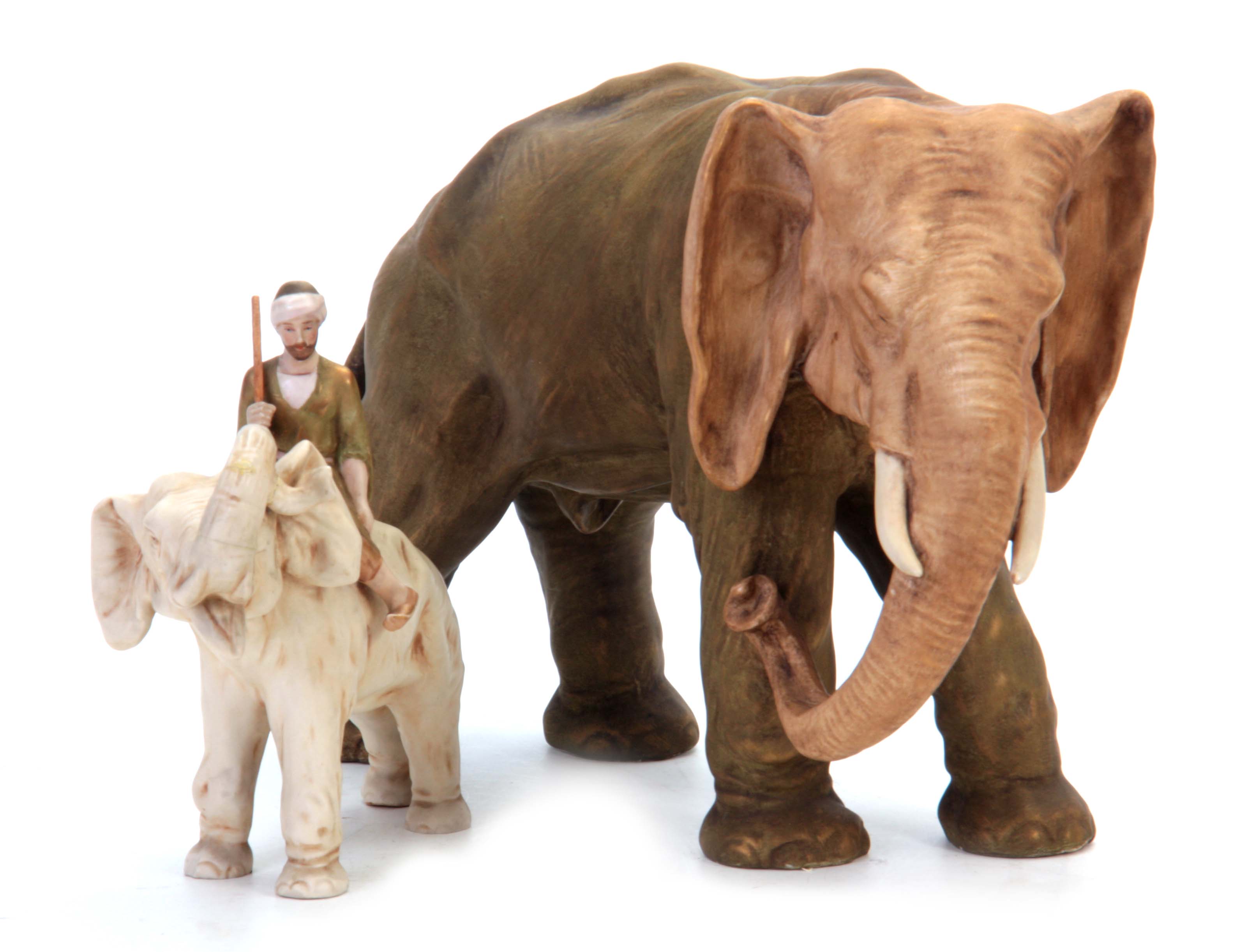 A ROYAL DUX LARGE ANIMAL MODEL of an elephant coloured in soft shades of green and brown with