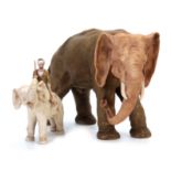 A ROYAL DUX LARGE ANIMAL MODEL of an elephant coloured in soft shades of green and brown with