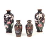 A PAIR OF CHINESE CLOISONNE ENAMEL OVOID VASES decorated extensive blossom sprays on a black