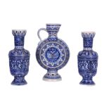 A PAIR OF LATE 19TH CENTURY WESTERWALD GERMAN STONEWARE VASES the dark blue glazed relief moulded