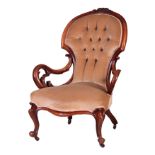 A VICTORIAN WALNUT BUTTON-BACK UPHOLSTERED ARMCHAIR with a floral carved frame, standing on cabriole