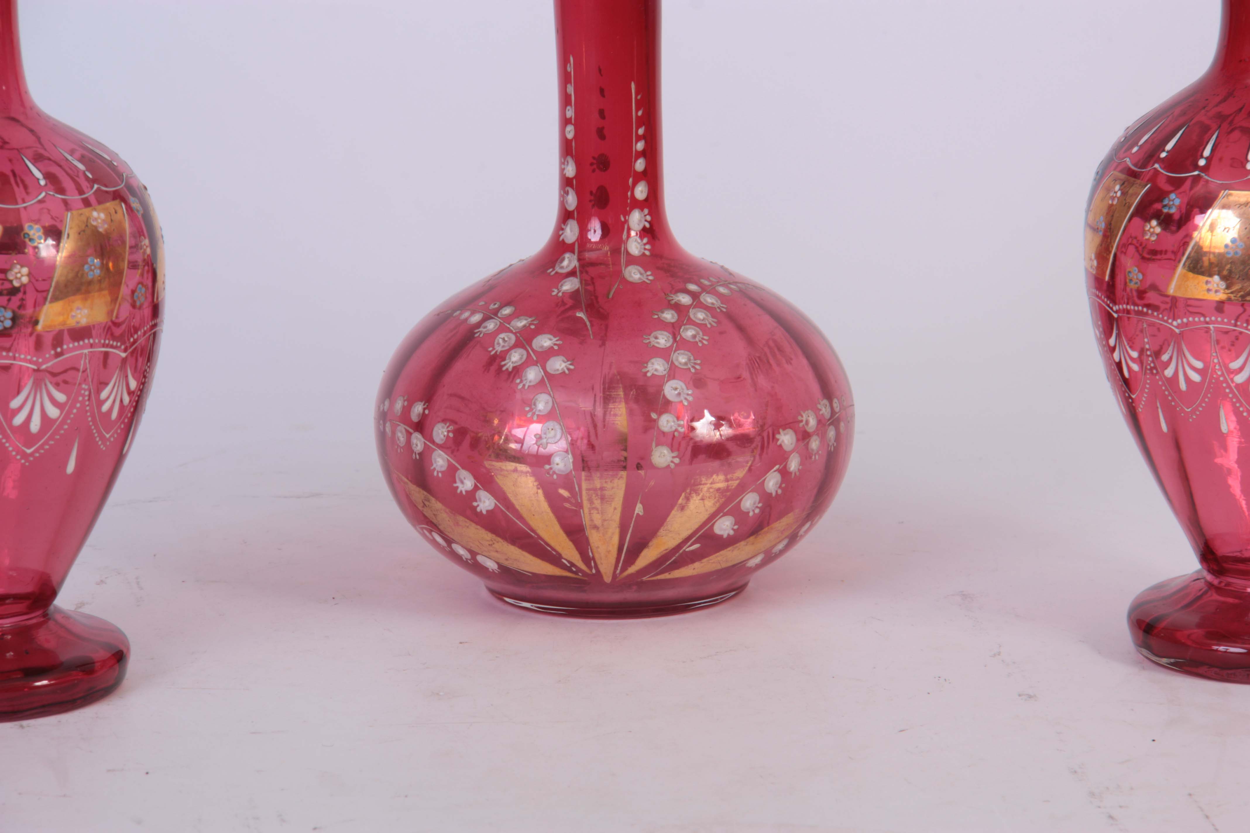 A PAIR OF VICTORIAN CRANBERRY DECANTERS with gilt panelled enamelled flower spray decoration to - Image 2 of 4