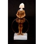 AN EARLY 20TH CENTURY ART DECO IVORY AND GILT BRONZE FIGURE of a young girl holding a hoop;