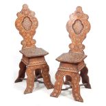 AN ELABORATE PAIR OF 19TH CENTURY EASTERN HARDWOOD AND BONE MARQUETRY INLAID HALL CHAIRS with shaped