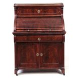 A 19TH CENTURY FLAME MAHOGANY FRENCH BIEDERMEIER STYLE TAMBOUR FRONTED DESK with brass gallery above