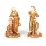 A PAIR OF ROYAL WORCESTER IVORY GROUND GILT EDGED COLOURED STANDING FIGURES modelled as a Navvy