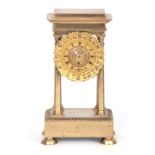 ROY, PARIS A SMALL EARLY 19TH CENTURY FRENCH ORMOLU PORTICO CLOCK with stepped pediment supported on