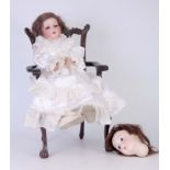 AN ARMAND MARSEILLE BISQUE DOLLS HEAD with sleeping eyes on a Bebe Jumeau body with silk dress,