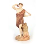 A ROYAL WORCESTER IVORY GROUND MALE STATUETTE modelled as a Satyr with coloured and gilt highlighted
