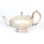 A VICTORIAN SMALL SILVER TEAPOT of plain compressed circular footed form with shaped handle and