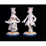 A PAIR OF BISQUE CLASSICAL STUMPWORK FIGURAL CANDLESTICKS 22cm high