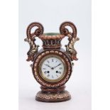 A 19TH CENTURY MAJOLICA CIRCULAR PEDESTAL TWO HANDLED MANTEL CLOCK the flattened urn-shaped brown