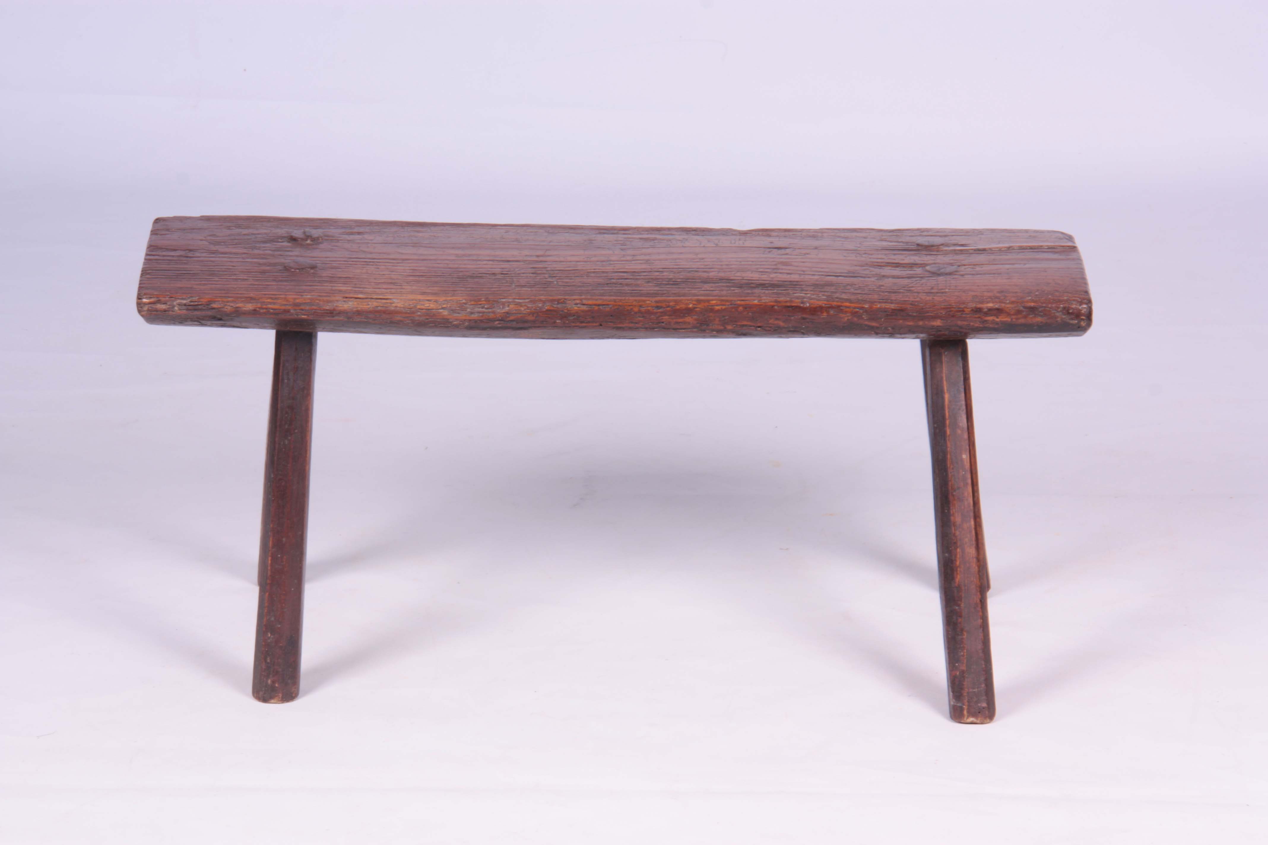 A PRIMITIVE 18TH CENTURY ELM PIG BENCH raised on four chamfered legs 77.5cm wide 24cm deep 35cm - Image 4 of 5