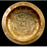 A 17TH CENTURY CONTINENTAL BRASS ALMS DISH probably Dutch/Flemish the hollowed centre embossed