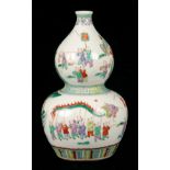 A CHINESE FAMILLE VERT DOUBLE GOURD VASE decorated with a festive figural scene, seal mark to