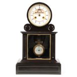 A LATE 19TH CENTURY FRENCH BLACK SLATE MANTEL CLOCK the arched top case with brass-framed bevelled