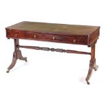 A REGENCY MAHOGANY WRITING TABLE with green tooled leather top, rounded corners and panelled