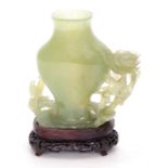 A 19TH CENTURY CHINESE JADE VASE ON HARDWOOD STAND with floral decoration and birds raised on a