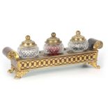 A REGENCY TORTOISESHELL AND BRASS INLAID BOULLEWORK INKSTAND with scrolled ends and ormolu lion