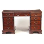 A LATE 19TH CENTURY MAHOGANY PEDESTAL DESK with leathered top above three frieze drawers having