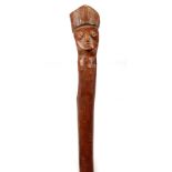 A 19TH CENTURY AFRICAN STICK with carved mask handle 51cm overall