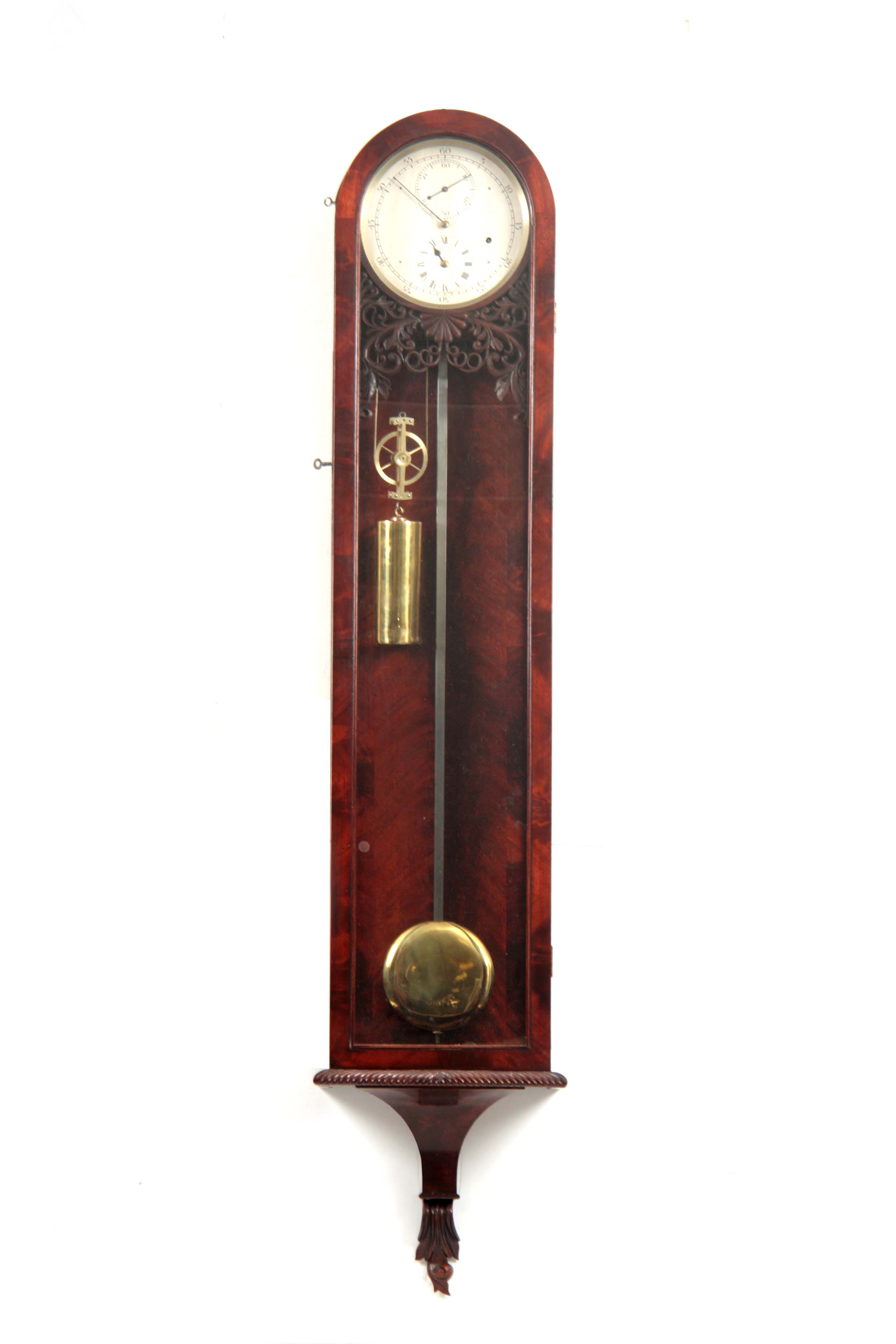 A GOOD QUALITY MID 20TH CENTURY FIGURED MAHOGANY REGENCY STYLE REGULATOR WALL CLOCK the arched top