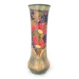 AN EARLY WILLIAM MOORCROFT FLARED TALL SLENDER VASE WITH SWOLLEN FOOT decorated all round in the