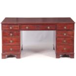 A LATE GEORGIAN MAHOGANY PARTNER'S DESK with gilt-edge burgundy leather top above a pair of side