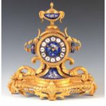 A LATE 19TH CENTURY FRENCH ORMOLU AND PORCELAIN PANELLED MANTEL CLOCK with urn finial above an