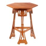 A 20TH CENTURY ART NOUVEAU STYLE OAK OCCASIONAL TABLE BY LIBERTY with pierced stylised leg