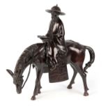 A CHINESE BRONZE SCULPTURE OF A SCHOLAR RIDING A HORSE the elderly gentleman wearing a hat reading