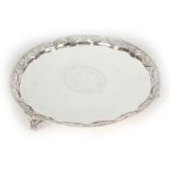 A GEORGE III SILVER SALVER with pierced gallery raised on matching feet, the centre with engraved