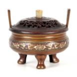 A 19TH CENTURY CHINESE BRONZE CENSER WITH CHAMPLEVE ENAMEL DECORATED BORDER having raised handles