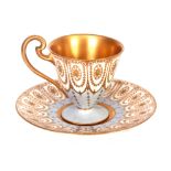 A ROYAL WORCESTER CABINET CUP AND SAUCER with pale blue and gilt jewel Adam style panelled