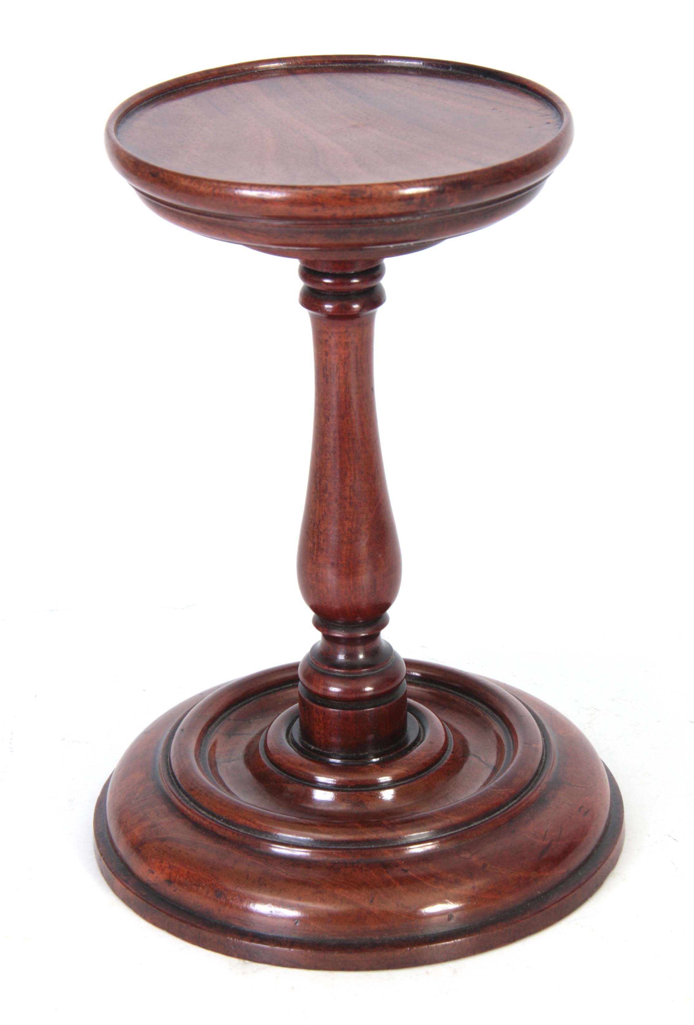 AN 18TH CENTURY MAHOGANY TURNED CANDLE STAND with ring turned bulbous stem and moulded base 22cm