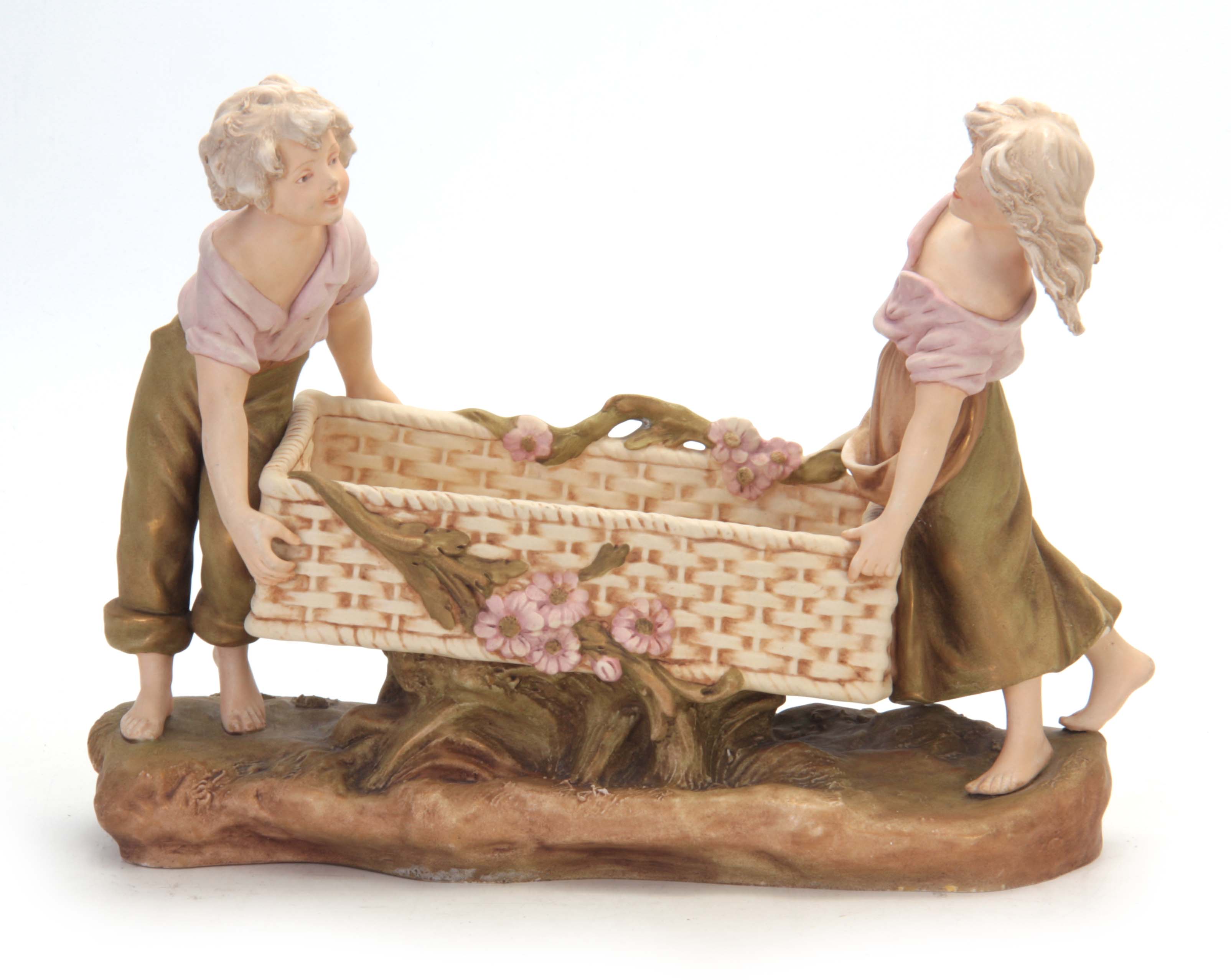 A LATE 19TH CENTURY ROYAL DUX BOHEMIAN FIGURAL TABLE CENTREPIECE modelled as a girl and boy