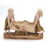 A LATE 19TH CENTURY ROYAL DUX BOHEMIAN FIGURAL TABLE CENTREPIECE modelled as a girl and boy
