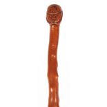 A 19TH CENTURY FOLK ART CARVED HAWTHORN WALKING STICK depicitig a soldier 92cm overall.