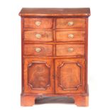 AN UNUSUAL MID 18TH CENTURY FLAME MAHOGANY SERPENTINE FRONTED SERVING CABINET with dummy drawer