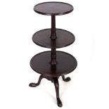 A 20TH CENTURY GEORGE III STYLE THREE TIER MAHOGANY DUMB WAITER with revolving lower tiers and