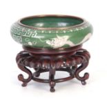 A CHINESE CLOISONNE BOWL ON STAND the green shallow bowl decorated with five claw dragons