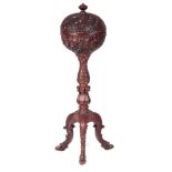 AN EARLY 19TH CENTURY CARVED HARDWOOD ANGLO INDIAN TEAPOY decorated with leaf work carving, having a