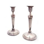 A PAIR OF GEORGE III SILVER CANDLESTICKS the circular crested bead edge bases supporting flared