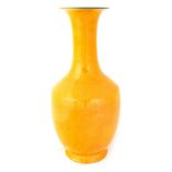 A CHINESE YELLOW GLAZED VASE with trumpet neck, turquoise glazed interior and underside with six-
