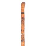 A 19TH CENTURY JAPANESE MALACCA SWORD STICK with carved entwined serpents and frogs, having a square