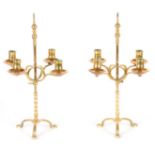 A PAIR OF EARLY CAST BRASS FOUR LIGHT ADJUSTABLE CANDLELARBRA on barley twist columns with turned