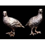 A PAIR OF SILVER GROUSE SCULPTURES with well cast standing male and female birds. 8.5cm high, app.