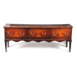 A LATE 18TH CENTURY LOW-WAISTED OAK DRESSER BASE with three frieze drawers fitted w brass swan-